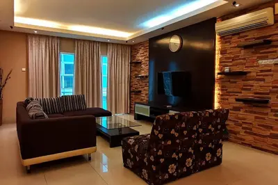 a living room with a couch and a tv at KLCC Luxurious 2 Floors Homestay 5BR for 15pax in Kuala Lumpur