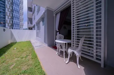 a balcony with two chairs and a table and a window at Zen 3-bedroom w pool 6 pax - Semarak in Kuala Lumpur