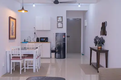 a kitchen and dining room with a table and a refrigerator at Zen 3-bedroom w pool 6 pax - Semarak in Kuala Lumpur