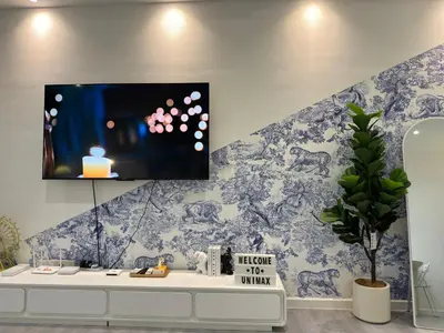 a living room with a tv on a wall at Chambers Suite Studio KLCC PWTC by Unimax in Kuala Lumpur
