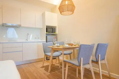 a kitchen and dining room with a table and chairs at Chambers Suite Studio KLCC PWTC by Unimax in Kuala Lumpur