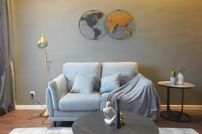 a living room with a blue chair and a table at Chambers Suite Studio KLCC PWTC by Unimax in Kuala Lumpur