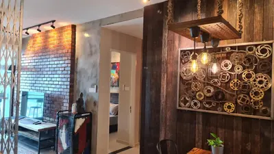 a dining room with a chandelier on the wall at Bricks & Beds Suite @ Legasi Kg Bahru in Kuala Lumpur