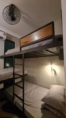 a bedroom with two bunk beds and a fan at Bricks & Beds Suite @ Legasi Kg Bahru in Kuala Lumpur