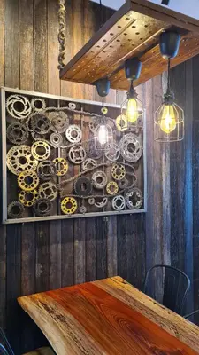 a room with a wooden wall with a table and lights at Bricks & Beds Suite @ Legasi Kg Bahru in Kuala Lumpur