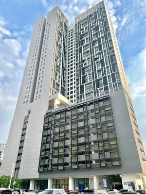 a tall building with cars parked in front of it at Chambers service suites klcc in Kuala Lumpur