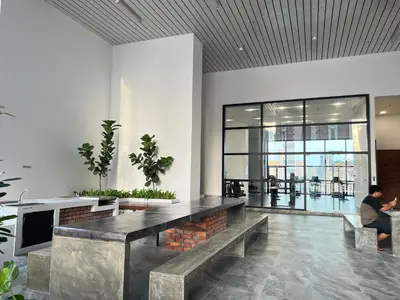 a lobby with a table and benches in a building at Chambers service suites klcc in Kuala Lumpur