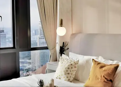 a bedroom with a bed with pillows and a window at Star residance KLCC-Two bedroom Apartment in Kuala Lumpur