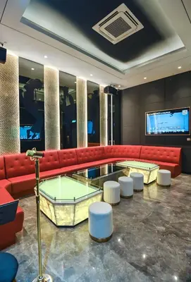 a lobby with a red couch and white stools at Star residance KLCC-Two bedroom Apartment in Kuala Lumpur