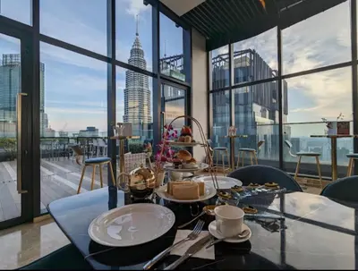 a table with food on it in a room with windows at Star residance KLCC-Two bedroom Apartment in Kuala Lumpur