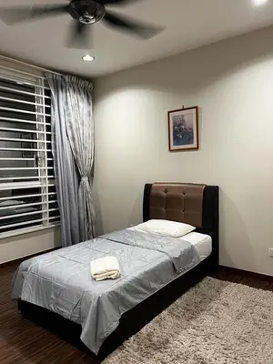 a bedroom with a bed with a ceiling fan at Zetapark, The Loft in Kuala Lumpur
