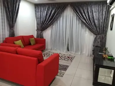 a living room with a red couch and curtains at Zetapark, The Loft in Kuala Lumpur