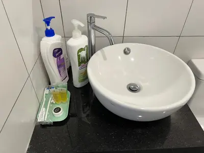 a white sink sitting on a counter in a bathroom at Chambers luxury suites KLCC in Kuala Lumpur