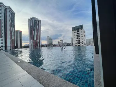 a swimming pool on top of a building with tall buildings at Chambers luxury suites KLCC in Kuala Lumpur