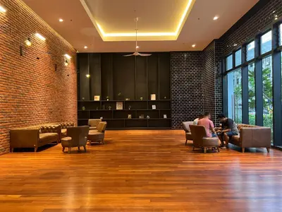 two people sitting in chairs in a waiting room at Chambers luxury suites KLCC in Kuala Lumpur