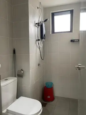 a bathroom with a toilet and a shower with a window at M Centura Sentul in Kuala Lumpur