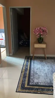a room with a table with a vase of flowers on it at M Centura Sentul in Kuala Lumpur
