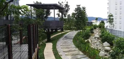 a garden with a fence and a walkway at The Harmony at Astoria Ampang - Mountain View in Kuala Lumpur