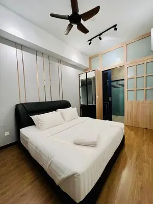 a bedroom with a large bed with a ceiling fan at The Harmony at Astoria Ampang - Mountain View in Kuala Lumpur