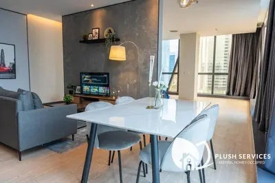 a living room with a white table and chairs at Bangsar Trade Centre in Kuala Lumpur