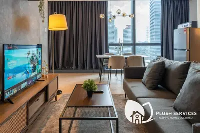 a living room with a couch and a tv at Bangsar Trade Centre in Kuala Lumpur