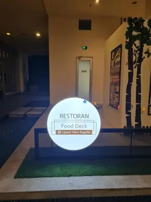 a white frisbee on the grass in front of a building at Hostel At Regalia Sky Pool in Kuala Lumpur