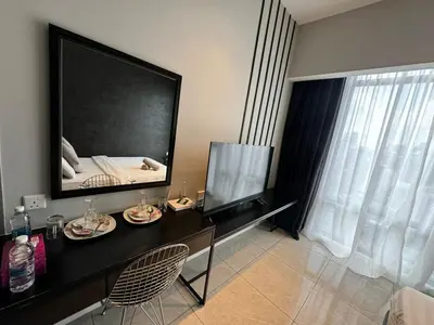 a living room with a large mirror on the wall at AXON SUITE aT BUKIT BINTANG KL near Pavillion in Kuala Lumpur
