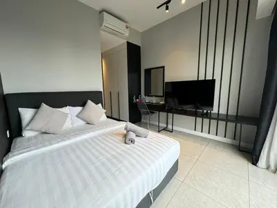 a bedroom with a bed and a television in it at AXON SUITE aT BUKIT BINTANG KL near Pavillion in Kuala Lumpur