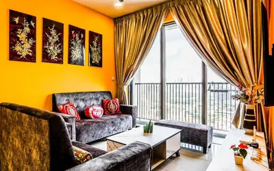 a living room with a couch and a table at Platz @ KL North Setapak by Airhost in Kuala Lumpur