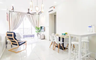 a white living room with a table and chairs at Platz @ KL North Setapak by Airhost in Kuala Lumpur
