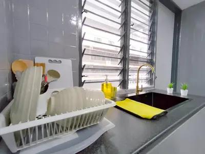 a kitchen with a sink and a counter with a yellow towel at Plaza Berjaya By Manhattan Group in Kuala Lumpur