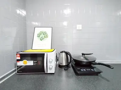 a microwave sitting on top of a counter with a pan at Plaza Berjaya By Manhattan Group in Kuala Lumpur