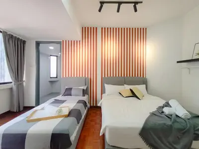 two beds in a room with red and white stripes at Plaza Berjaya By Manhattan Group in Kuala Lumpur