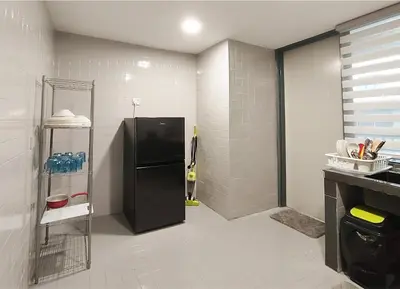 a kitchen with a black refrigerator in a room at Plaza Berjaya By Manhattan Group in Kuala Lumpur