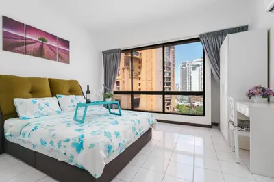 a bedroom with a bed and a large window at Plaza Berjaya Apt Bukit Bintang With 3 Bedroom in Kuala Lumpur
