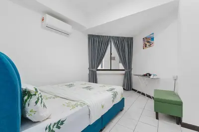 a bedroom with a bed and a window and a chair at Plaza Berjaya Apt Bukit Bintang With 3 Bedroom in Kuala Lumpur