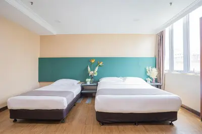 two beds in a room with blue and white at Hotel 28 Titiwangsa in Kuala Lumpur