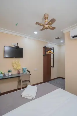 a bedroom with a bed and a ceiling fan at Hotel 28 Titiwangsa in Kuala Lumpur