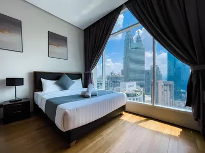 a bedroom with a bed and a large window at Soho Suites KLCC by Wakely Kuala Lumpur in Kuala Lumpur