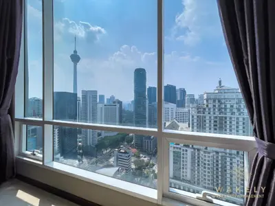 a window with a view of a city skyline at Soho Suites KLCC by Wakely Kuala Lumpur in Kuala Lumpur