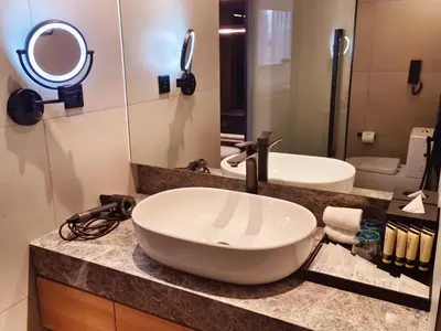 a bathroom with a sink and a mirror at Hotel Royal Signature in Kuala Lumpur