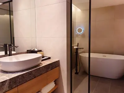 a bathroom with a sink and a bath tub at Hotel Royal Signature in Kuala Lumpur