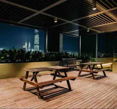 two picnic tables on a deck with a view of the city at Sunway Velocity link velo mall Muji-2BR \u4e2d\u6587\u623f\u4e1c in Kuala Lumpur