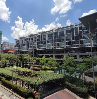 a large building with a garden in front of it at Sunway Velocity Suite link velocity mall in Kuala Lumpur