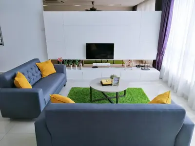 a living room with a blue couch and a table at Setapak Central Signature Suites by Manhattan Group in Kuala Lumpur