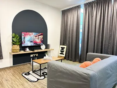 a living room with a couch and a tv at Setapak Central Signature Suites by Manhattan Group in Kuala Lumpur