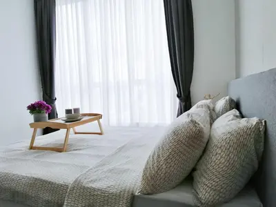a bedroom with a bed with pillows and a table at Setapak Central Signature Suites by Manhattan Group in Kuala Lumpur
