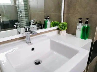 a white sink in a bathroom with a mirror at Setapak Central Signature Suites by Manhattan Group in Kuala Lumpur