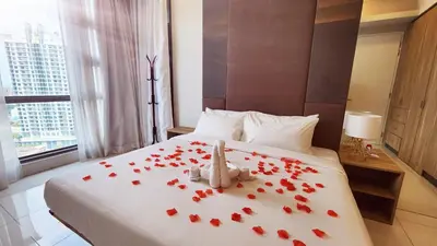 a bedroom with a bed with red roses on it at Balcony Unit @ Robertson Residence 18f in Kuala Lumpur