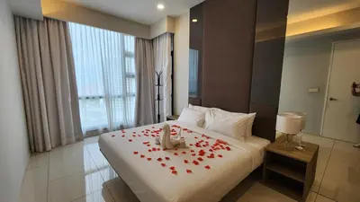 a hotel room with a bed with red roses on it at Balcony Unit @ Robertson Residence 18f in Kuala Lumpur